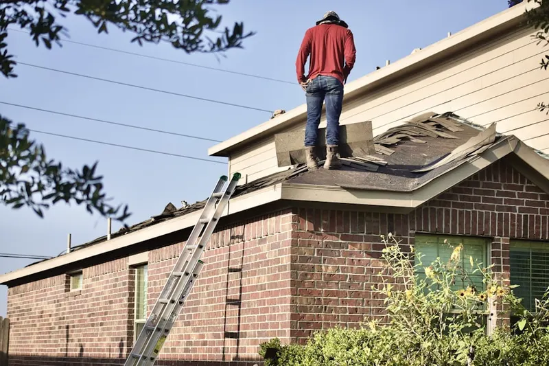 Professional roofer working on a residential roof in Anderson